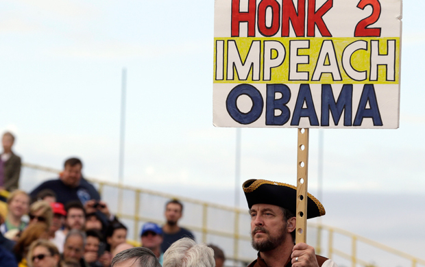 A man holds a sign while attending a rally for Steve Lonegan, who is running for the vacant New Jersey seat in the U.S. Senate, Saturday, October 12, 2013, in New Egypt, New Jersey. (AP/Julio Cortez)