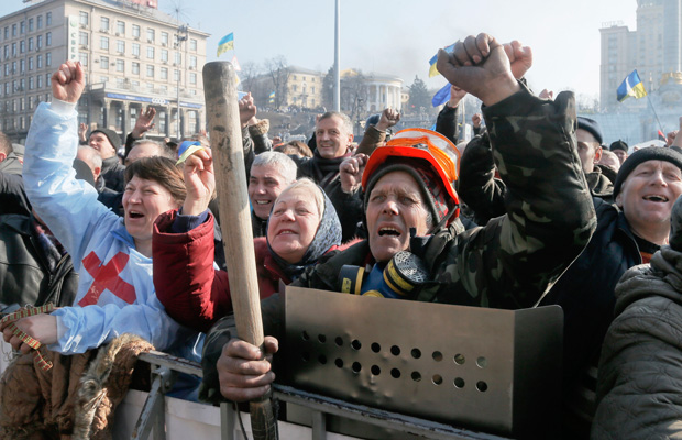 People raise their fists during a rally in Independence Square, the epicenter of the country's current unrest, in Kiev, Ukraine, Friday, February 21, 2014. (AP/Efrem Lukatsky)