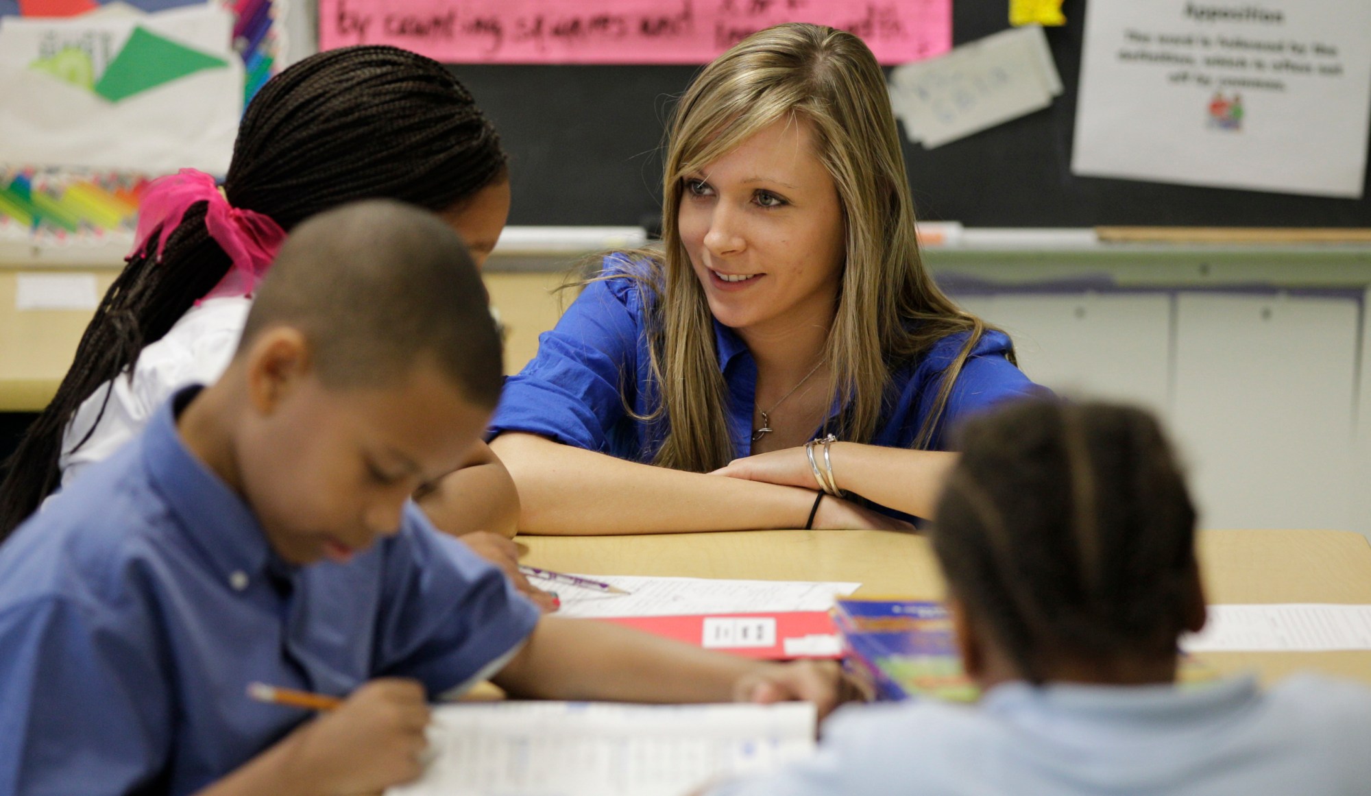 Jennifer Ries, a third-grade teacher at Belmont Elementary in Baltimore, works with students in her class. (AP/Rob Carr)