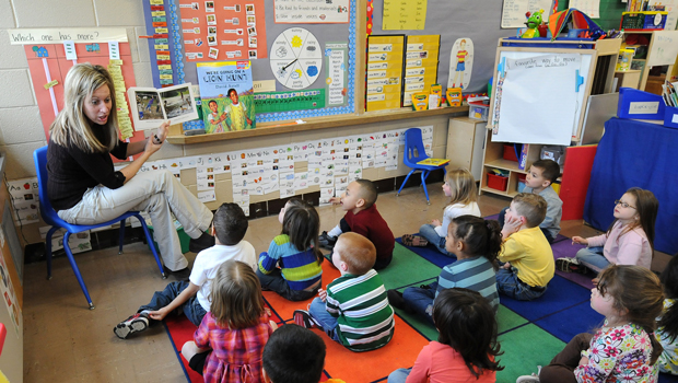 Angie Clark, a preschool teacher, reads to a group of 4- and 5-year-old students at Mitchell Elementary School, Tuesday, March 29, 2011, in Des Moines, Iowa. (AP/Steve Pope)