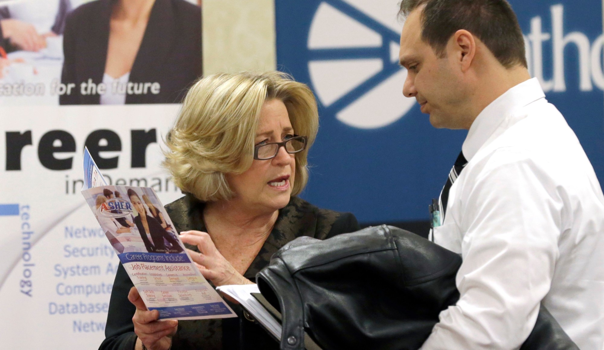 Recruiter Valera Kulow, left, speaks with job seeker Leonardo Vitiello during a career fair in Dallas. (AP/LM Otero)