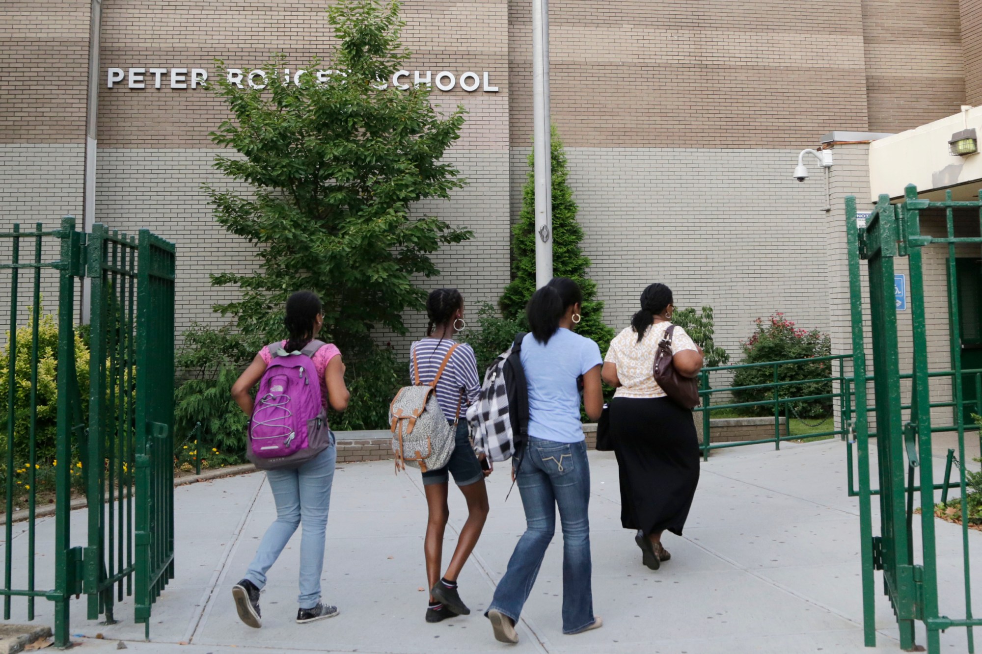 Students enter Middle School 88, a New York City public school in Brooklyn, on August 7, 2013. (AP/Mark Lennihan)