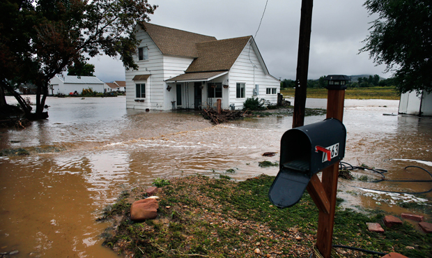Water flows through an evacuated neighborhood after days of flooding in Hygiene, Colorado, Sunday, September 15, 2013. (AP/Brennan Linsley)