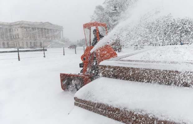 A Capitol Hill worker clears snow on Capitol Hill in Washington, D.C. (AP/J. Scott Applewhite)