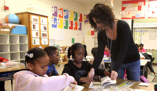 Teacher Lori Peck helps first grader Timia Harris at Grace L. Patterson Elementary school in Vallejo, California. (AP/Rich Pedroncelli)