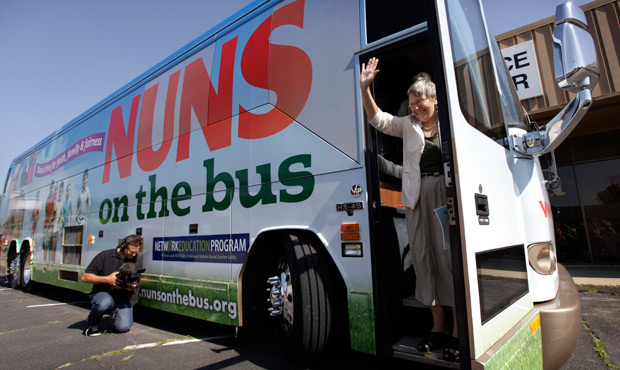 Sister Simone Campbell, executive director of NETWORK, waves as she steps off the bus during a stop on the first day of a nine-state Nuns on the Bus tour, Monday, June 18, 2012, in Ames, Iowa. (AP/Charlie Neibergall)