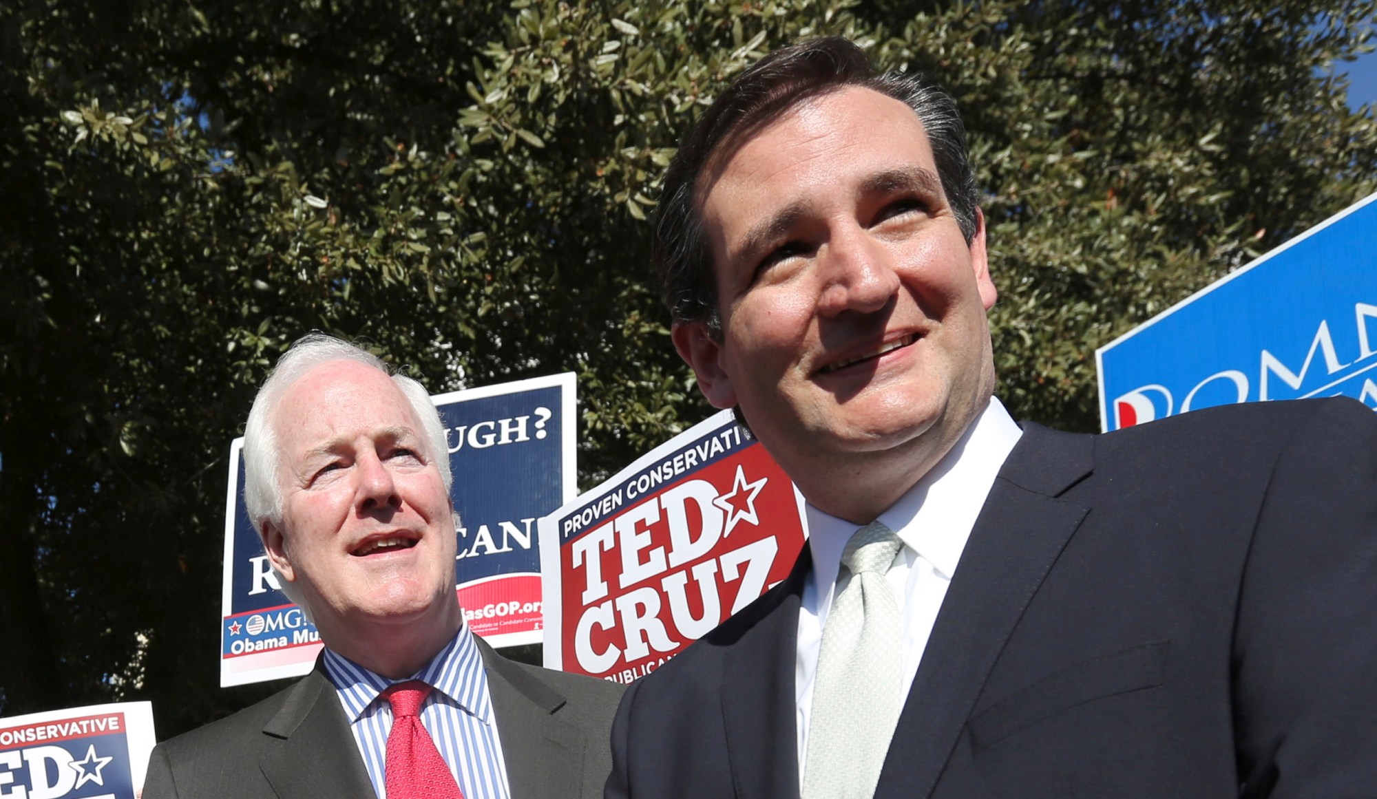 Then-Senate candidate Ted Cruz (R-TX), right, and Sen. John Cornyn (R-TX) listen to a question from reporters outside a polling station in Dallas. (AP/LM Otero)