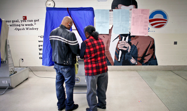 People cast their votes Tuesday, November 6, 2012, at a polling location inside the Benjamin Franklin Elementary School in Northeast Philadelphia. (AP/Joseph Kaczmarek)
