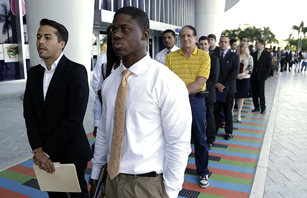Luis Mendez, 23, left, and Maurice Mike, 23, wait in line at a job fair held by the Miami Marlins at Marlins Park in Miami, Florida, on October 23, 2013. (AP/Lynne Sladky)