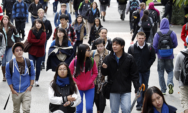 University of Washington students walk on the campus between classes in Seattle. (AP/Elaine Thompson)