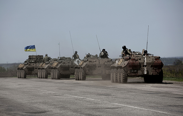 A column of Ukrainian armored vehicles makes its way along the road between Kharkiv and Slovyansk, Ukraine, Thursday, April 24, 2014. (AP/Manu Brabo)
