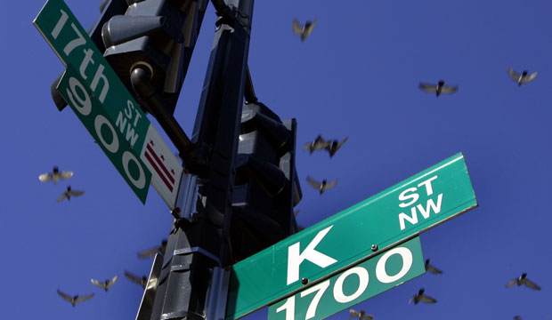 Pigeons fly over the intersection of 17th and K streets in Washington, D.C. K Street has long been invoked as shorthand for moneyed lobbyists who ply influence in the city. (AP/Charles Dharapak)