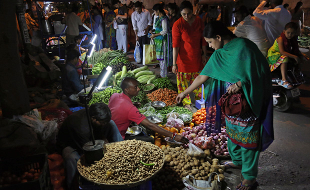 People buy vegetables at a market in Hyderabad, India, Saturday, March 15, 2014. (AP/Mahesh Kumar A.)