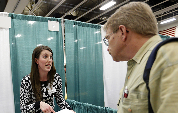 Erin Wilson, of Hannaford Bros. supermarket company, left, talks with a job seeker during a job fair at Columbia-Greene Community College in Hudson, New York, April 22, 2014. (AP/Mike Groll)