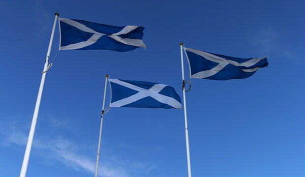 A trio of Scottish Saltire flags are displayed at the Scottish border. (AP/Scott Heppell)
