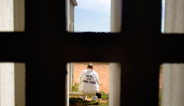 A prisoner sits in the yard of the state prison in Jackson, Georgia. (AP/David Goldman)