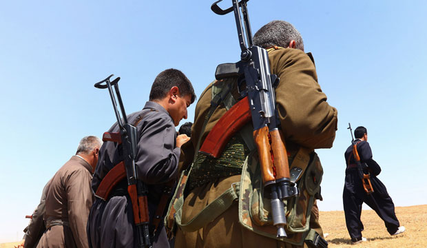 Kurdish Peshmerga security forces stand guard in the outskirts of the northern city of Mosul, Iraq, on Saturday, June 14, 2014. (AP Photo)