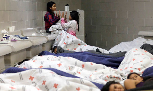 Detainees play as others sleep in a holding cell at a U.S. Customs and Border Protection processing facility in Brownsville, Texas. (AP/Eric Gay)