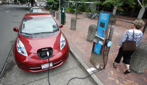 Nissan Leaf charges at a electric vehicle charging station. (AP/Rick Bowmer)