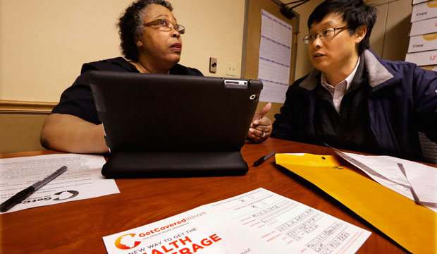 Navigator Mary Bennett, left, helps Min Lians, who is seeking help buying health insurance under the Affordable Care Act at the Family Guidance Center in Springfield, Illinois. (AP/Seth Perlman)