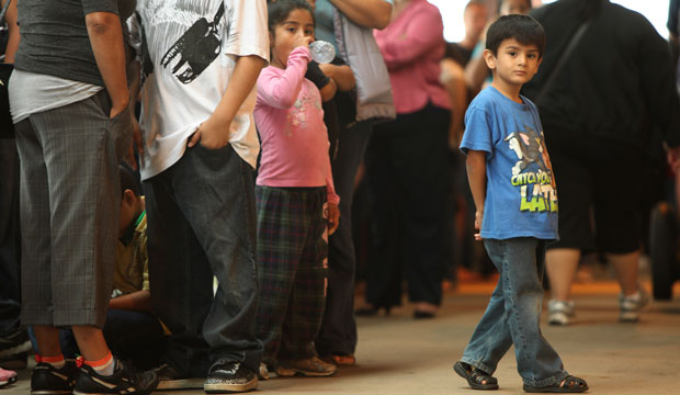 Children stand in line with some of the thousands of young immigrants at Chicago's Navy Pier. (AP/Sitthixay Ditthavong)