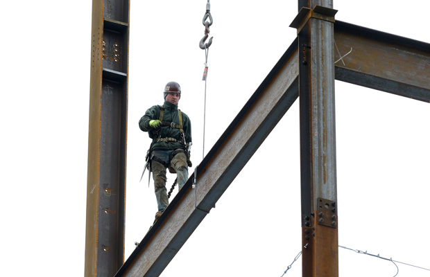 A worker positions iron girders at a building construction site in Boston. Today, the Bureau of Economic Analysis released second-quarter gross domestic product. (AP/Steven Senne)