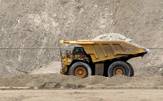 A house-sized dump truck hauls dirt and rock at the Black Thunder coal mine in northeast Wyoming's Powder River Basin near Wright, Wyoming. (AP/Mead Gruver)