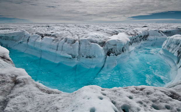 Melt water rushes along the surface of the Greenland Ice Sheet through a supraglacial stream channel, southwest of Ilulissat, Greenland. (AP/Ian Joughin)