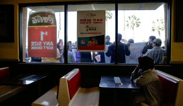 Demonstrators gather outside a McDonald's restaurant to protest for higher wages and overtime pay in Huntington Park, California. (AP/Jae C. Hong)