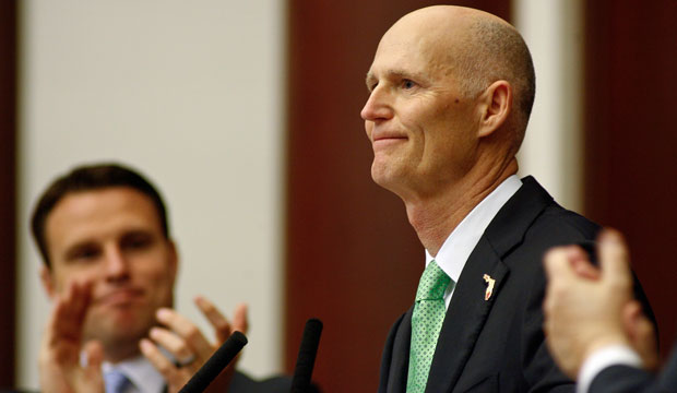 Florida Gov. Rick Scott is applauded by Florida House Speaker Will Weatherford. (AP/Phil Sears)