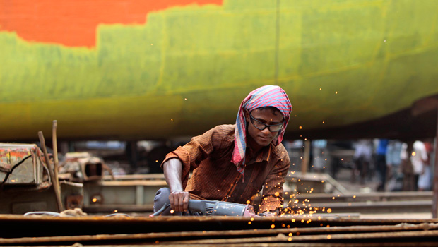 A laborer works on a ferry being refurbished at a dockyard in Keraniganj, near Dhaka, Bangladesh. (AP/A.M. Ahad)