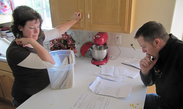 Ben and Amber Sessions look over real-estate documents at their rental home in Rexburg, Idaho, on June 9, 2011. (AP/Jessie L. Bonner)
