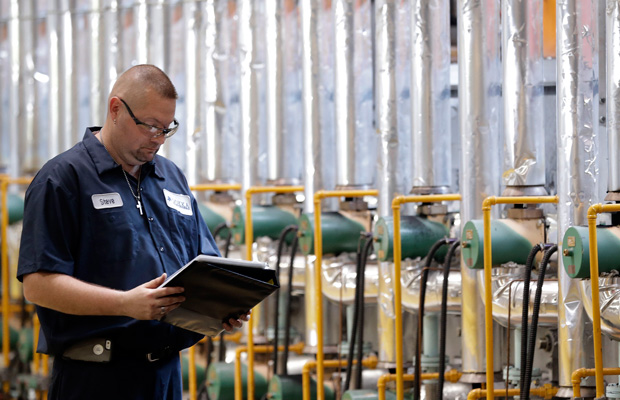 Steve Hawkins checks on a furnace at Dokka Fasteners training program in Auburn Hills, Michigan. (AP/Paul Sancya)