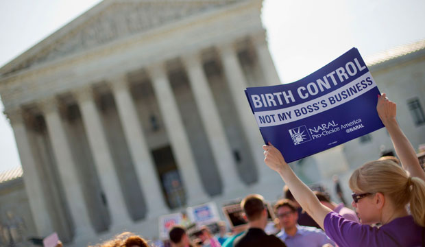 A demonstrator holding up a sign outside the Supreme Court in Washington, D.C., June 2014. (AP/Pablo Martinez Monsivais)