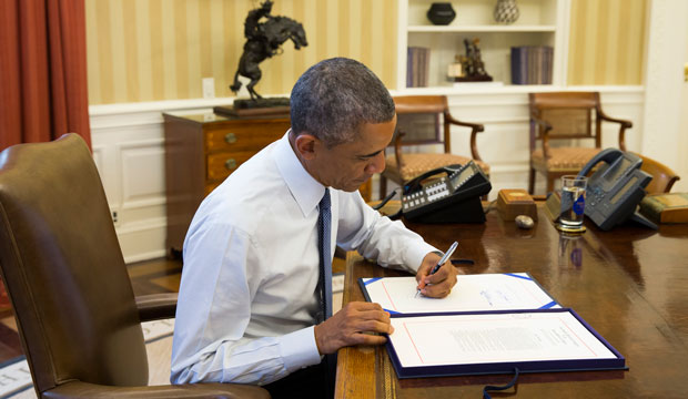 President Barack Obama signs H.J. Res 124, which includes appropriations to train and arm moderate Syrian rebels in the fight against ISIS, on September 19, 2014. (AP/Evan Vucci)