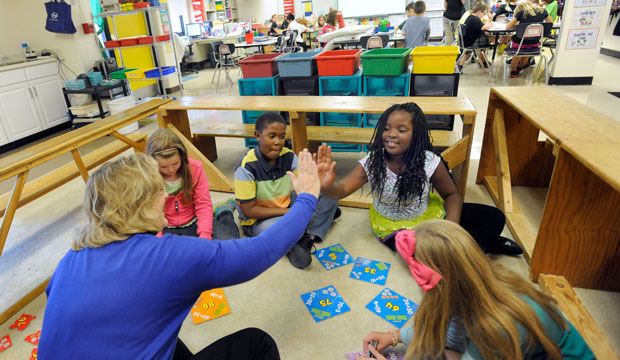 Third-grade teacher Sherry Frangia high-fives student Jayla Hopkins during a math lesson at Silver Lake Elementary School in Middletown, Delaware, in October 2013. (AP/Steve Ruark)