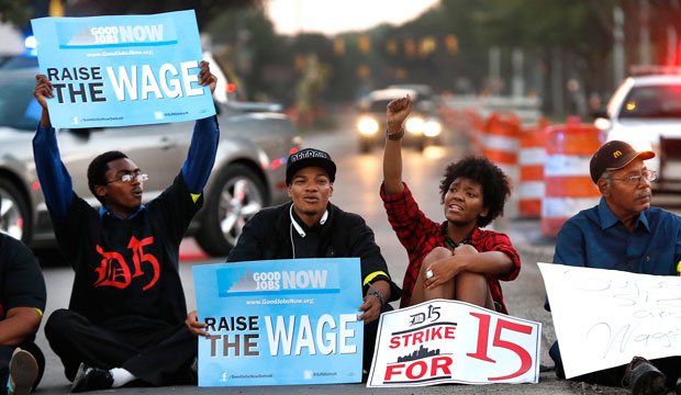 Protesters block traffic on Mack Avenue in Detroit, Michigan, as part of a national protest to push fast-food chains to pay their employees at least $15 per hour on September 4, 2014. (AP/Paul Sancya)