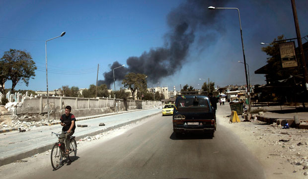 Black smoke leaps into the air from shelling by pro-Assad forces in a residential area in Aleppo, Syria. (AP/Manu Brabo)