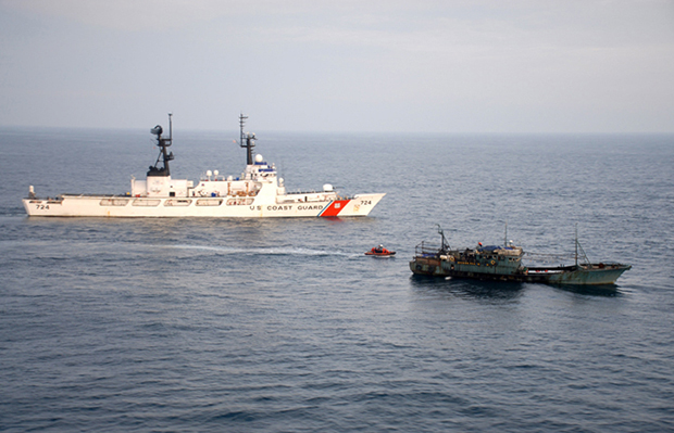 The U.S. Coast Guard Cutter Munro, in cooperation with a People’s Republic of China Fisheries Law Enforcement Command officer, seizes a Chinese fishing vessel suspected of illegal high-seas drift-net fishing 460 miles east of Hokkaido, Japan. (U.S. Coast Guard)