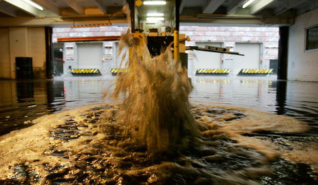 A sewer overflows as city pipes cannot hold the water brought by severe weather in Cleveland, Ohio. (AP/Tony Dejak)
