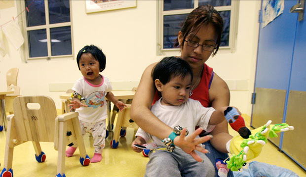 Jenny Gomez plays with her son Brandon Garcia, right, and Jocelyn Nava, left, at Edward A. Reynolds West Side High School's LYFE Center on August 7, 2007, in New York City. (AP/Mary Altaffer)