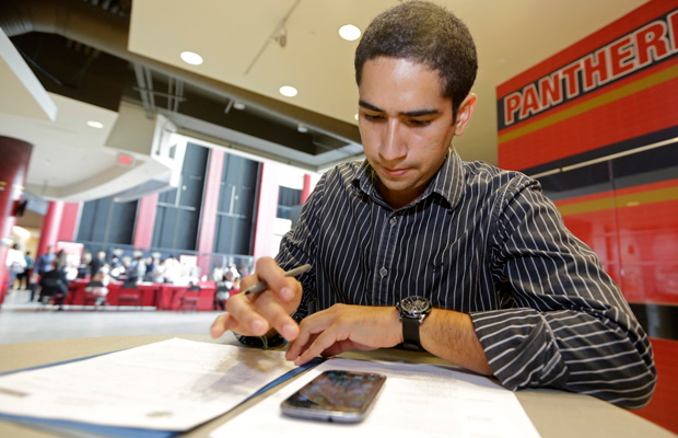 Freddy Jerez fills out a job application during a job fair in Sunrise, Florida. (AP/Alan Diaz)