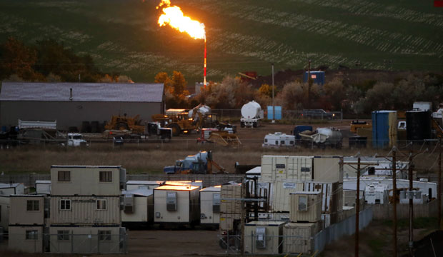 A natural gas flare lights up the night sky in Williston, North Dakota. (AP/Charles Rex Arbogast)