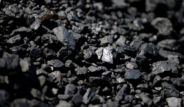 Sunlight reflects off of a chunk of coal at Dominion Terminal Associates' coal terminal in Newport News, Virginia, May 2014. (AP/Patrick Semansky)