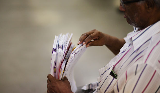 Amde-Meskel Kaffel, of Powder Springs, Georgia, holds paperwork as he attempts to apply for a home loan at a mortgage relief event in Atlanta. (AP/David Goldman)