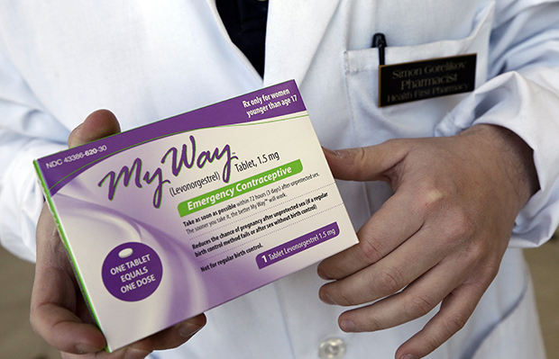 Pharmacist Simon Gorelikov holds a generic emergency contraceptive, also called the morning-after pill, at the Health First Pharmacy in Boston, Massachusetts, May 2, 2013. (AP/Elise Amendola)