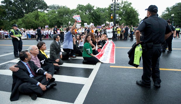 Immigration reform supporters block a street on Capitol Hill on Thursday, August 1, 2013, in protest against immigration policies and the House’s inability to pass a bill that contains a pathway to citizenship. (AP/Manuel Balce Ceneta)