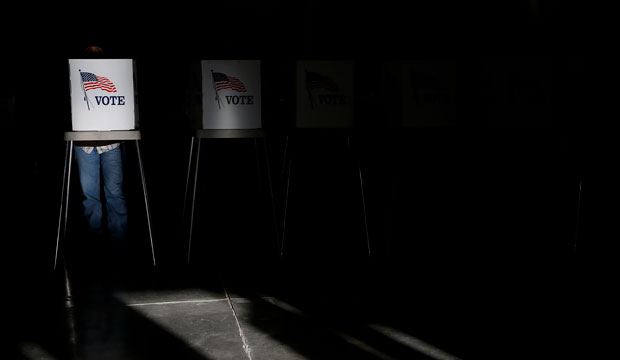 Voting booths are illuminated by sunlight as voters cast their ballots at a polling place in Billings, Montana. (AP/Jae C. Hong)