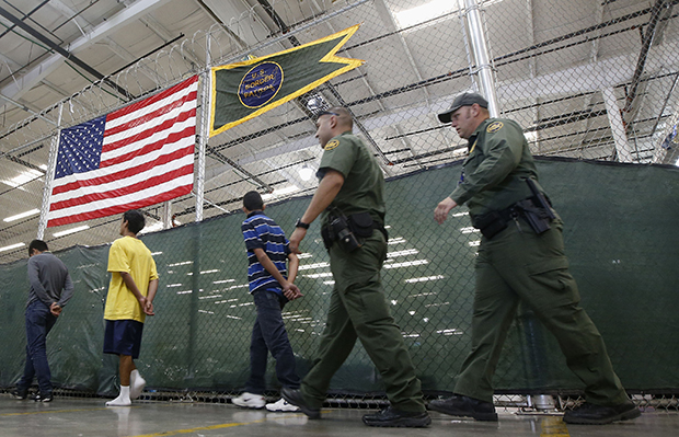 Young detainees are escorted to an area to make phone calls at the U.S. Customs and Border Protection Nogales Placement Center in Nogales, Arizona, June 18, 2014. (AP/Ross D. Franklin)