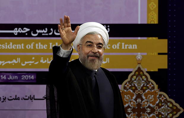 Iranian President Hassan Rouhani waves after speaking at a press conference in Tehran, Iran, June 14, 2014. (AP/Vahid Salemi)